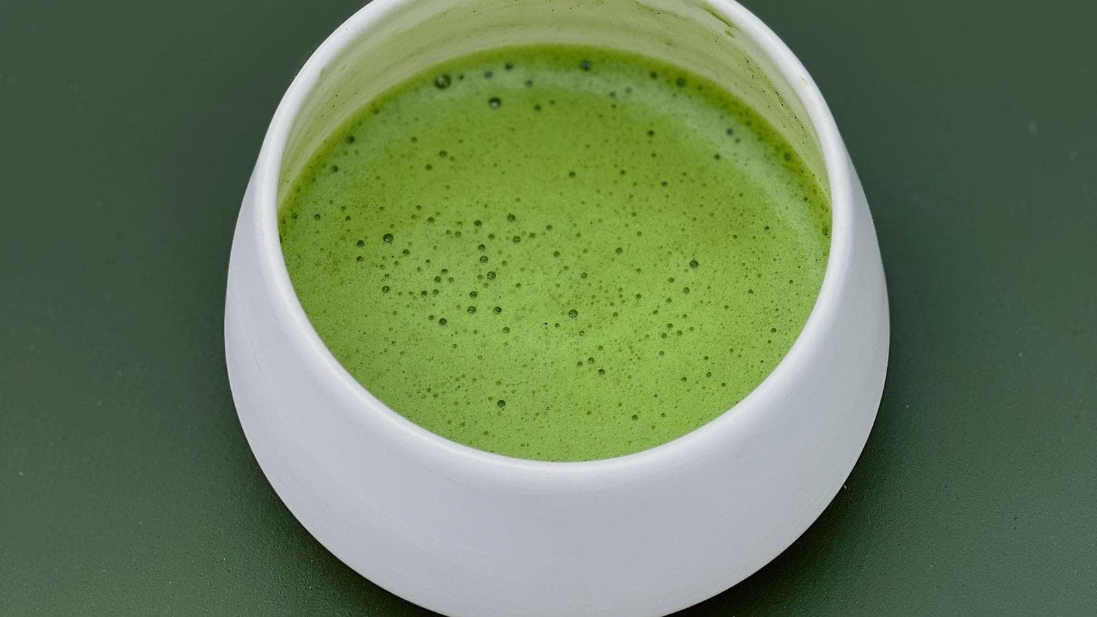 Whisked bright green usucha in a plain white cup