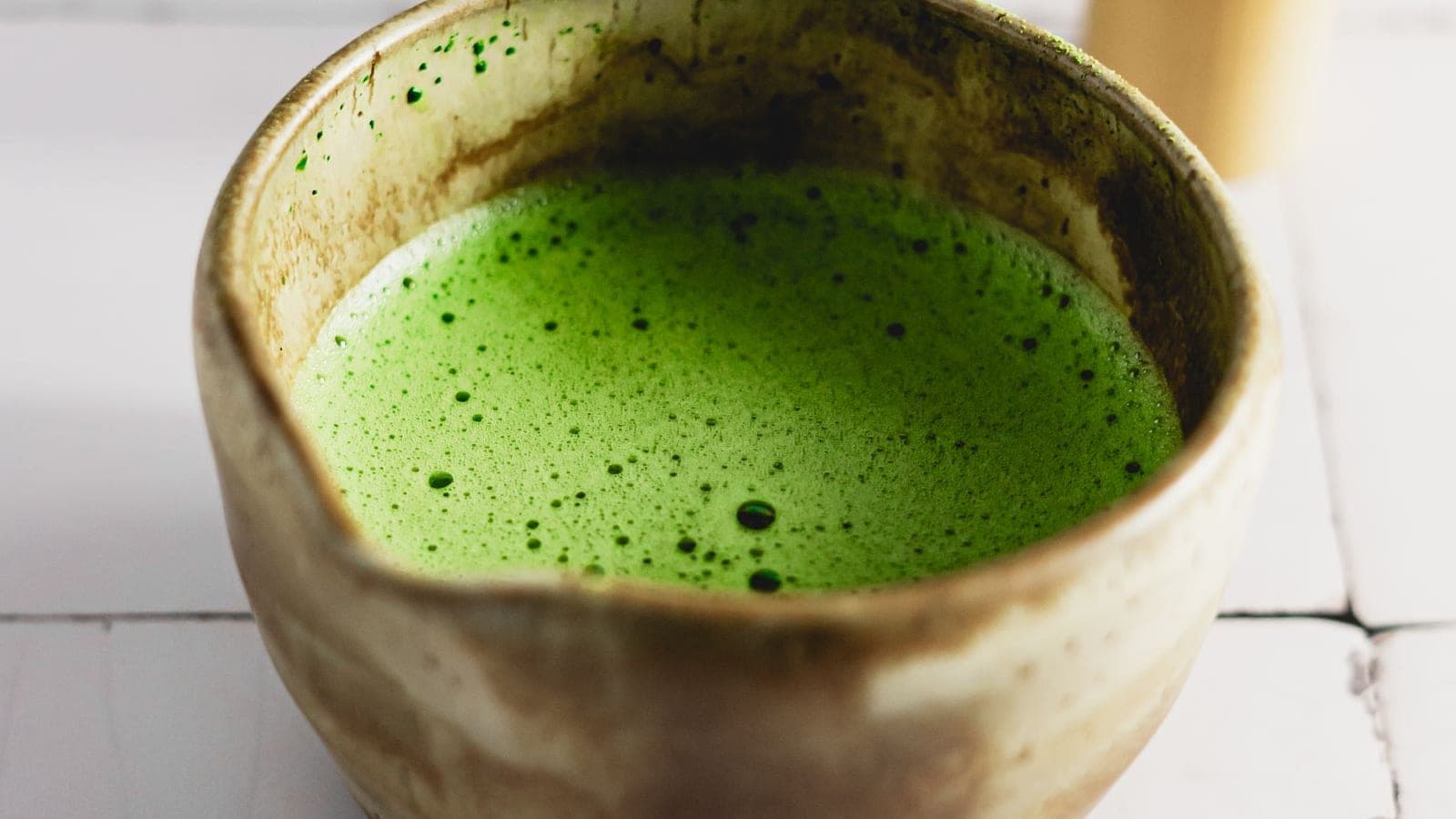 Frothy bright green usucha in a rustic ceramic tea bowl